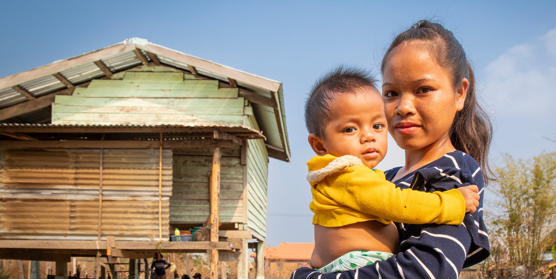 A local mother and her baby in a rural community of Laos