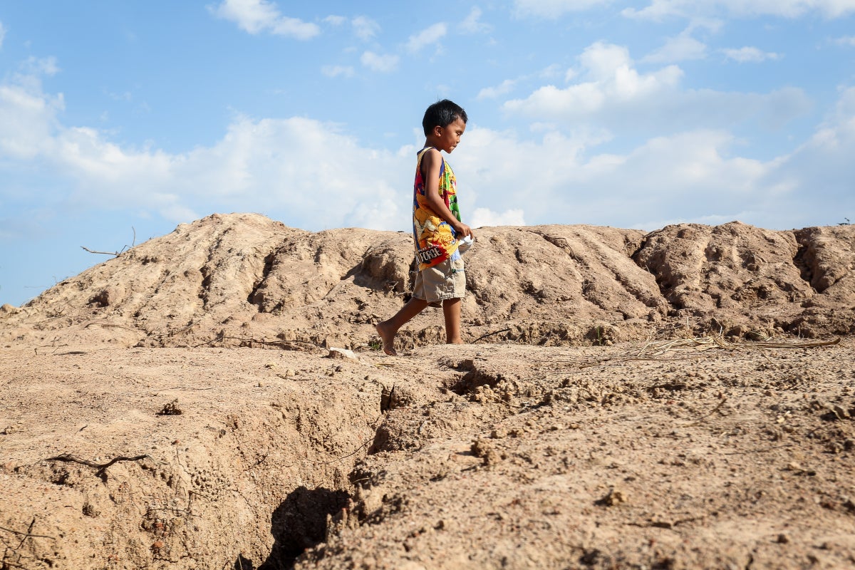 Child walking on dry earth