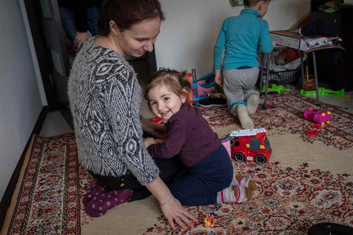 Sivlana plays with her daughter Milana, three, at a friend’s house after fleeing war in Ukraine.
