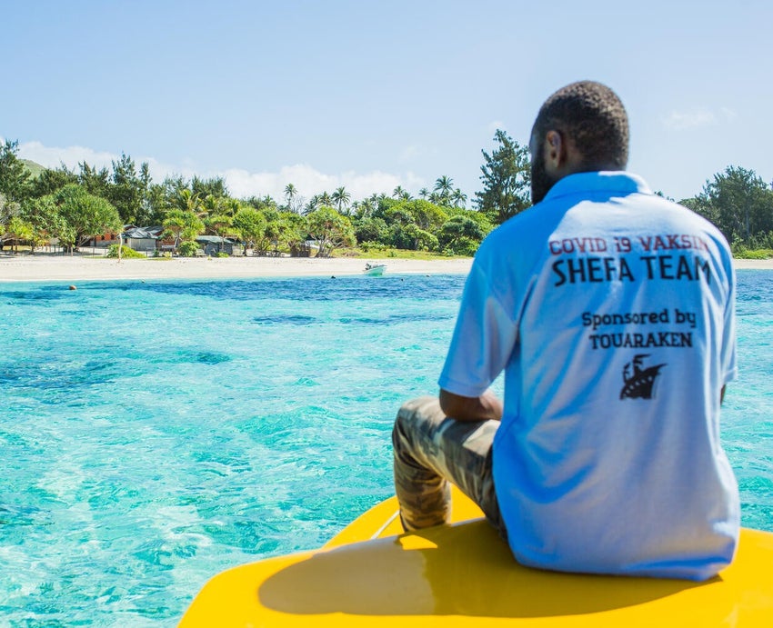 A registered nurse travels by boat to a Vanuatu island to deliver vaccines to the local community.