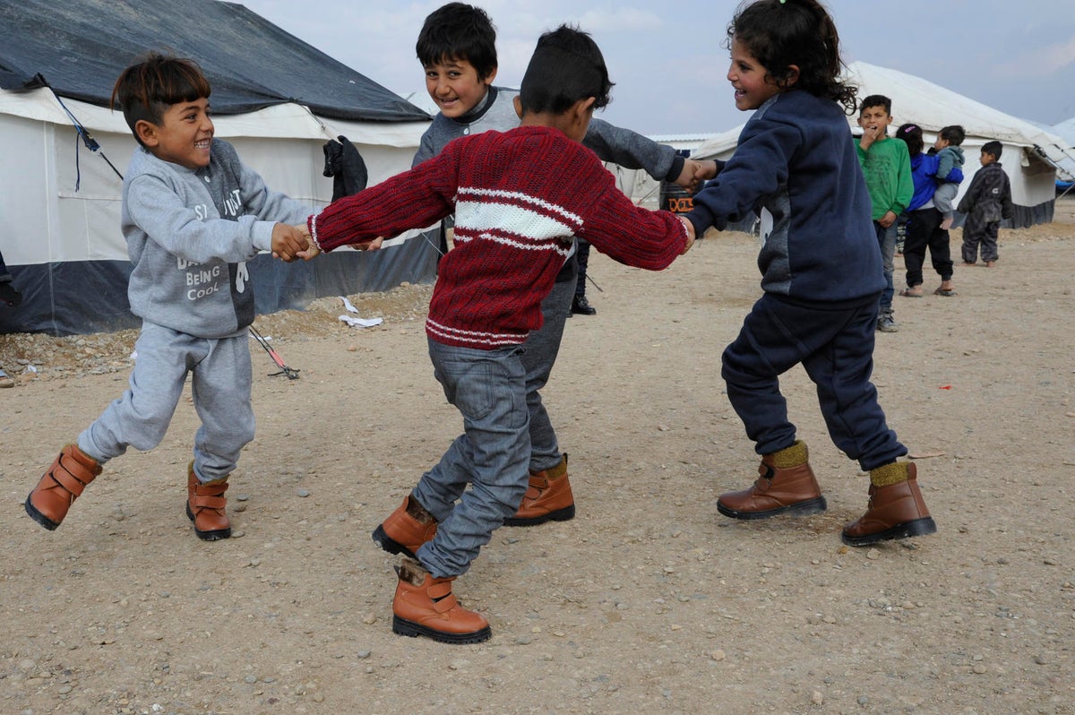 Four boys playing. They look happy.