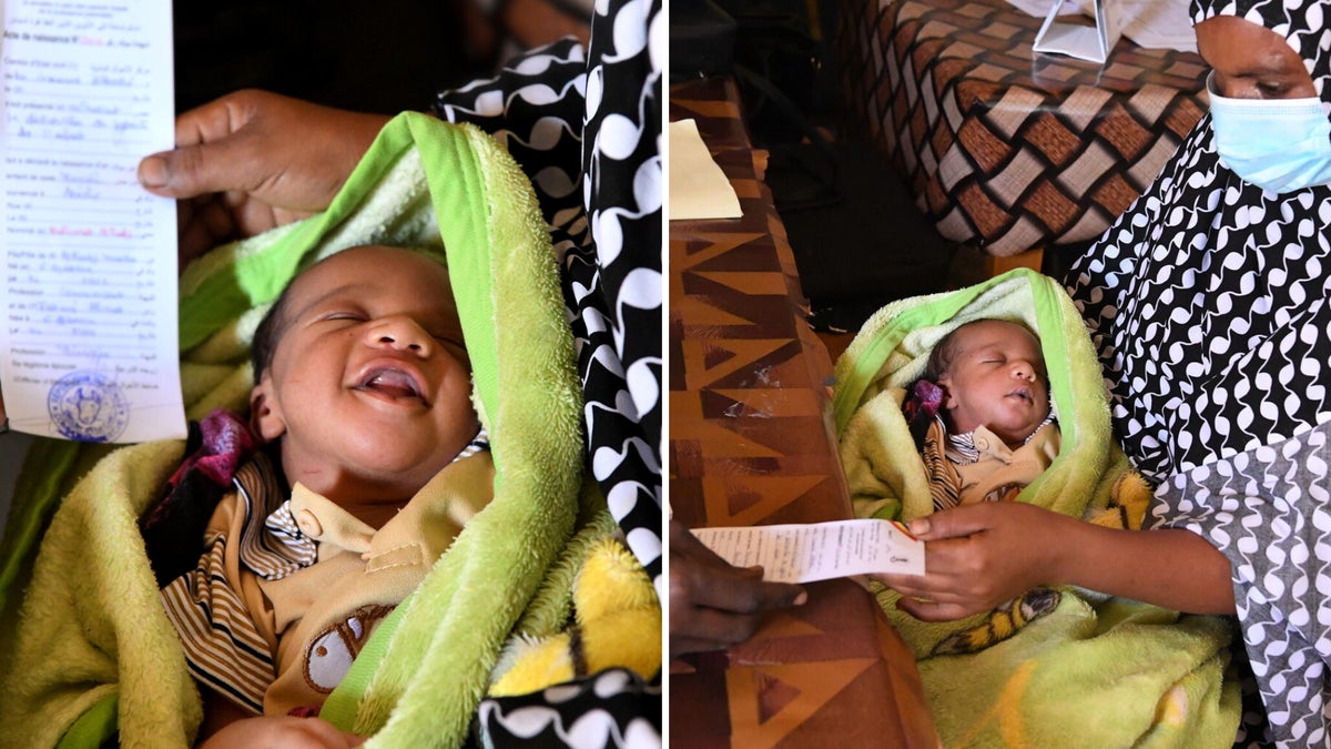 A newborn baby next to his birth certificate.