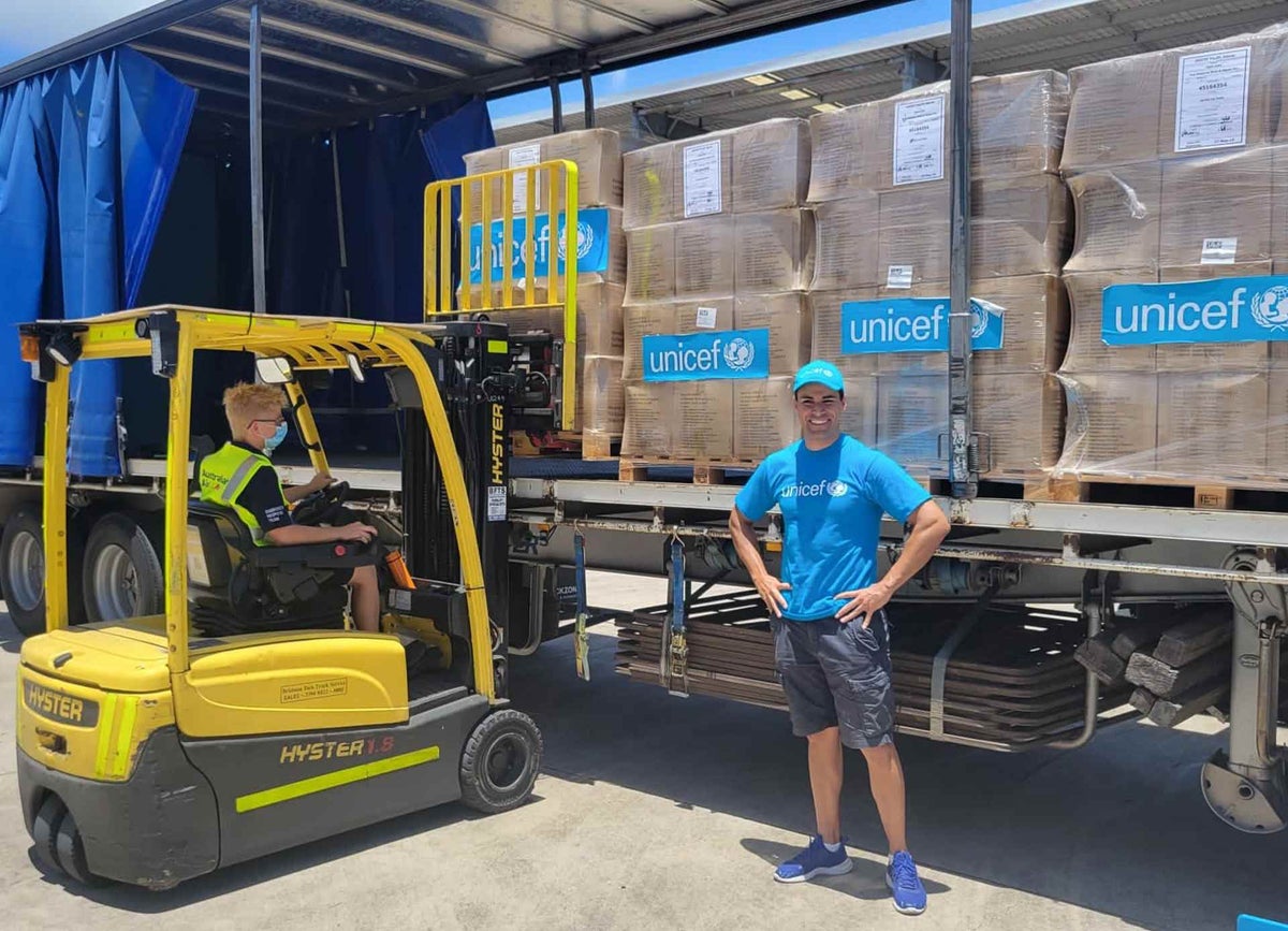 UNICEF Pacific Ambassador Pita Taufatofua stands in front of UNICEF's pre-positioned emergency supplies at our warehouse in Brisbane, Australia. 