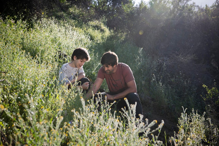 A father and son talking to each other about climate change