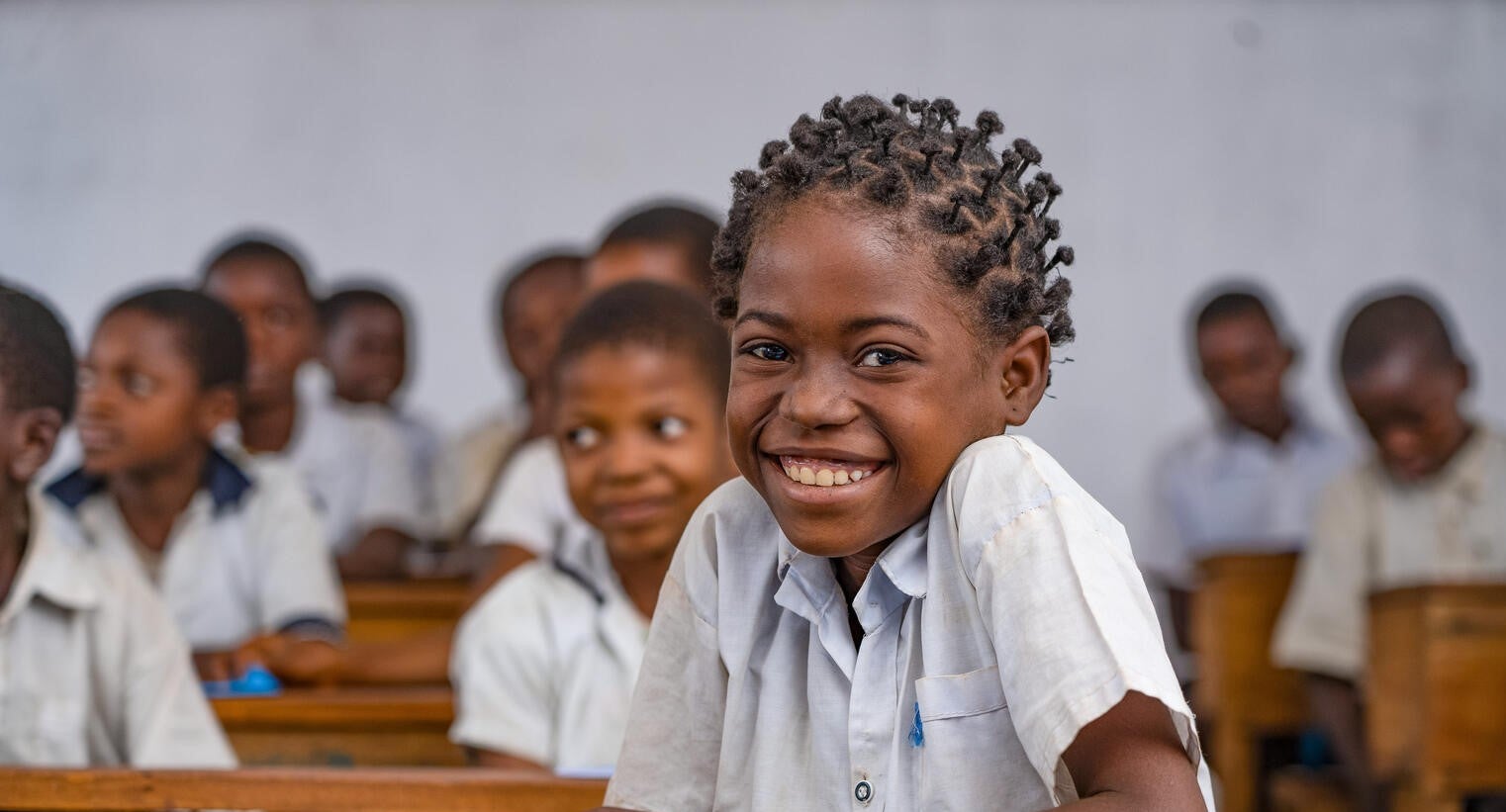 A school student in DRC smiling at the camera