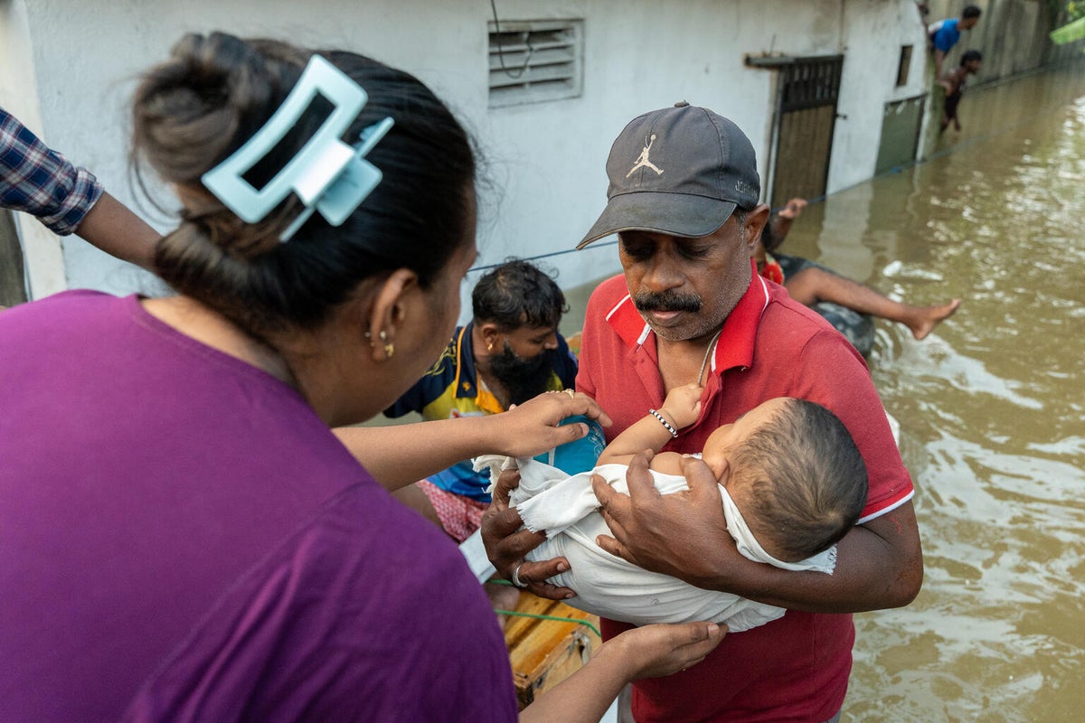 In Sri Lanka, boats rescue families stranded in their homes by dangerous flood waters following Cyclone Ditwah.