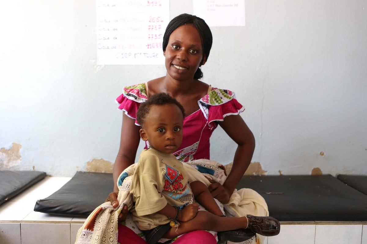Maimoma Fall waits with her son Ibrahima at a health post in Senegal for his routine immunisations in 2013. 