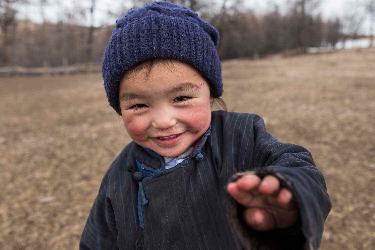 Child looking at the camera smiling.