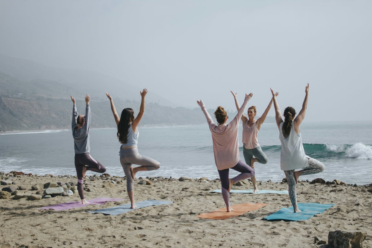 Four girls doing a fitness workout on the beach