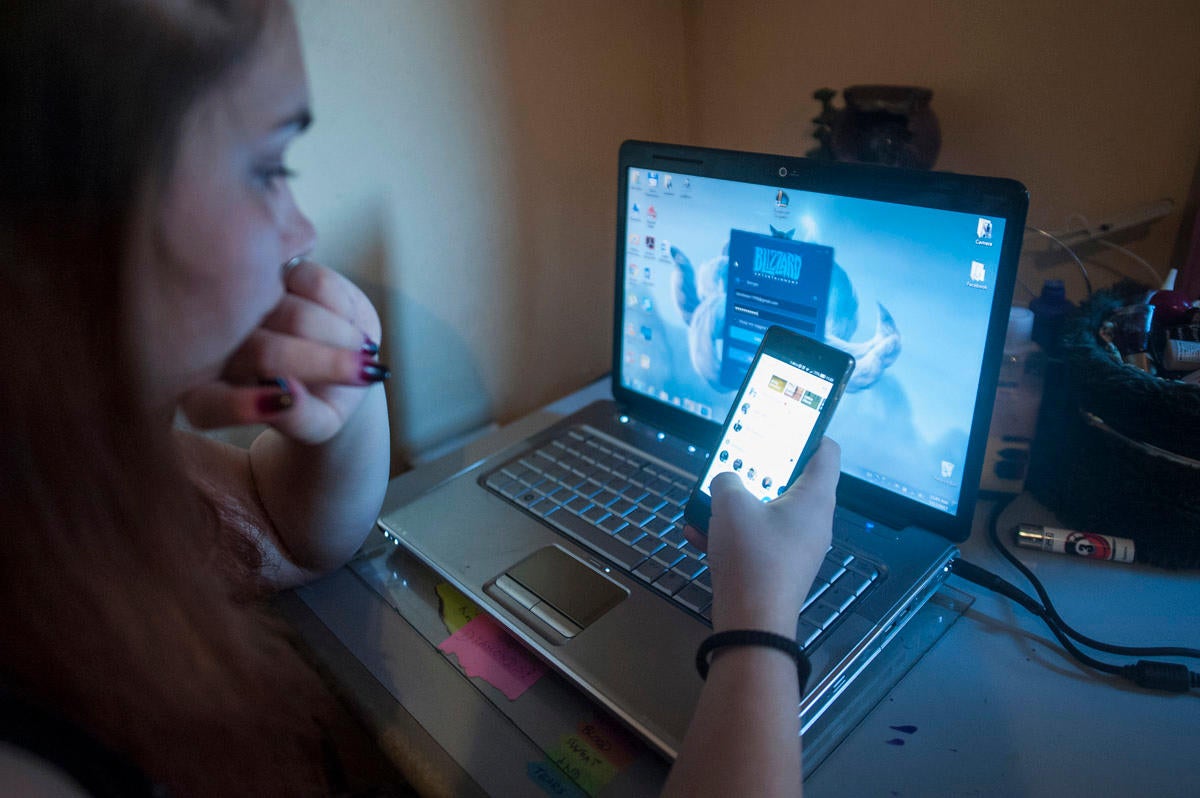 Young girl looking at her devices