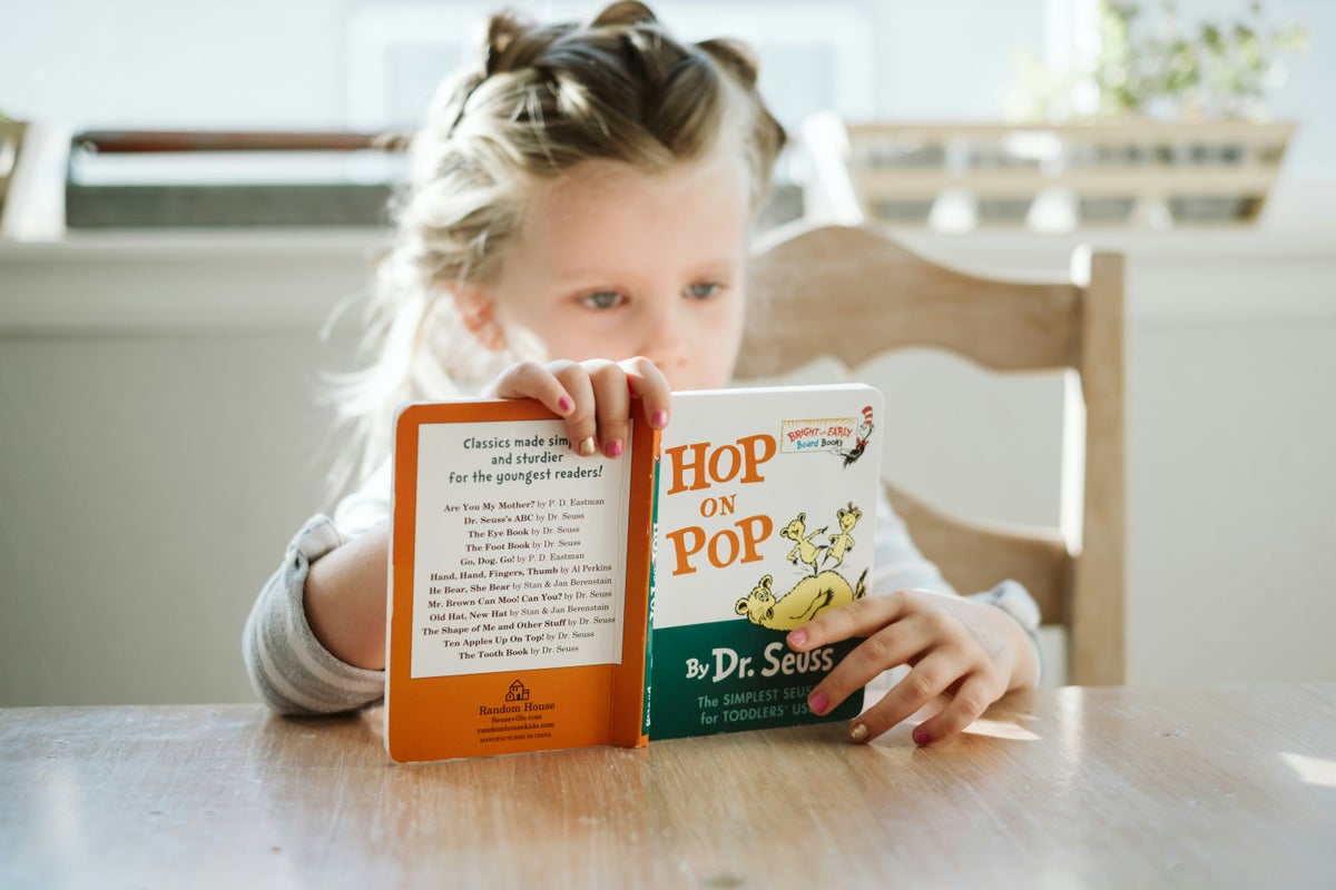 A girl reading a children's book