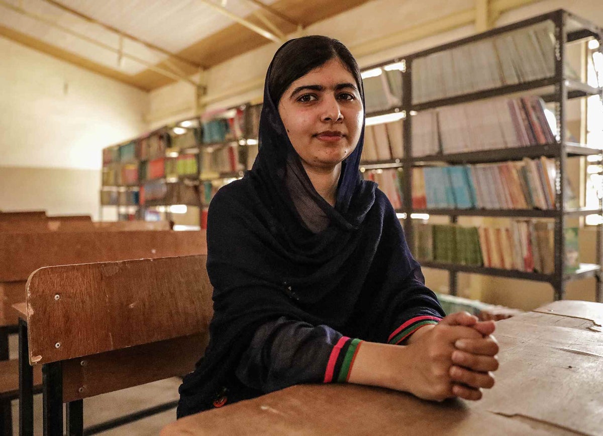 Malala sits in library