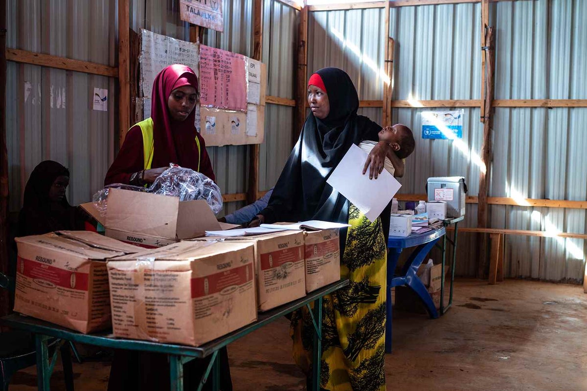 At Kabasa camp for internally displaced people in Dollow, Somalia, children and their mothers receive a daily supplement of energy and nutrient-dense food to add to their diet