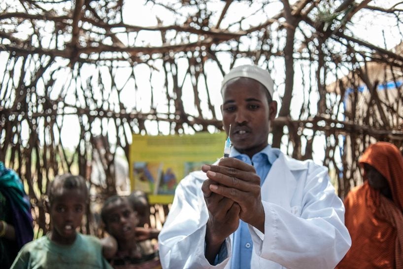 A health worker preparing a syringe to apply a vaccine