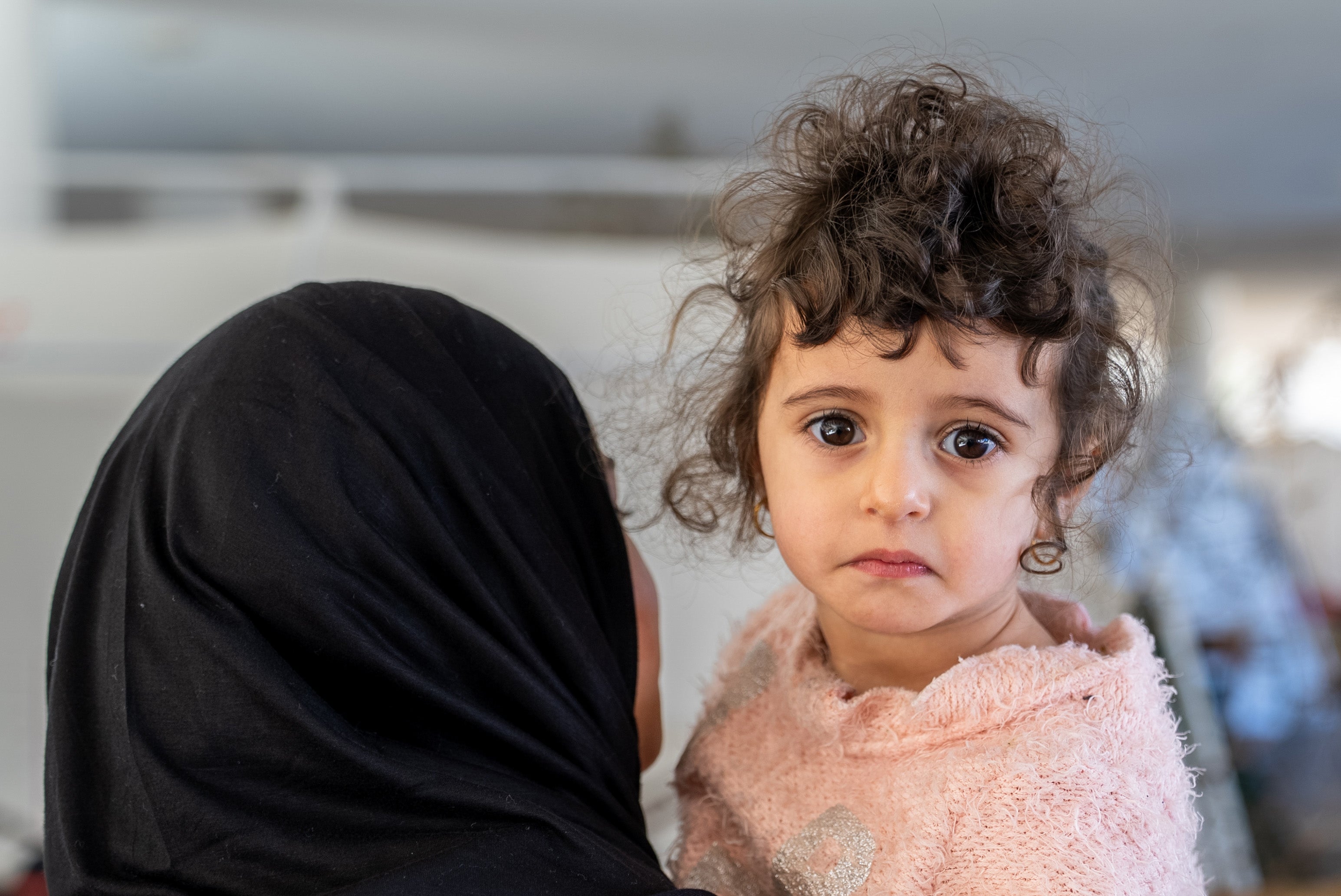 A child in a women's arms.