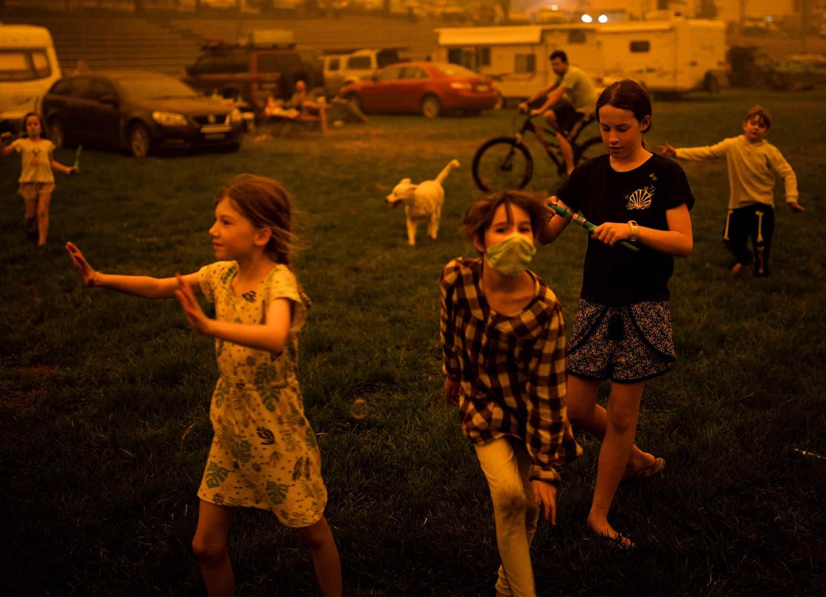Children play at the showgrounds in a southern New South Wales town where they are camping after being evacuated from nearby sites affected by bushfires in December 2019.
