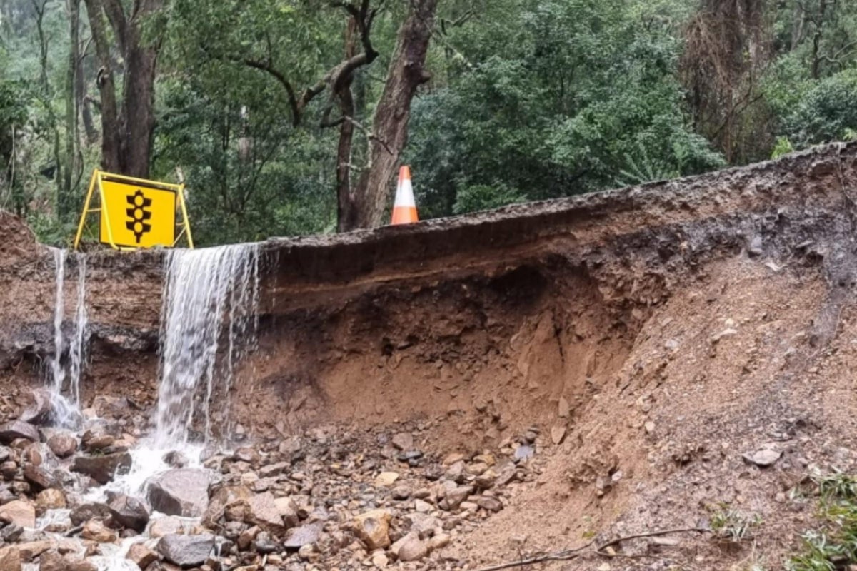A road washed away by floodwaters.