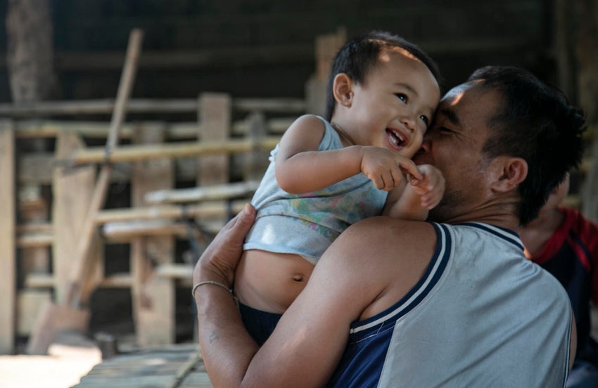 Father and son cuddling and smiling