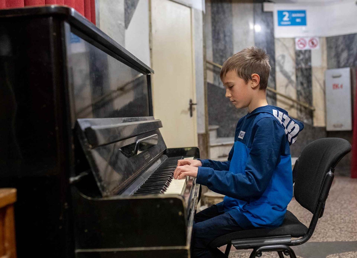 Young boy plays piano