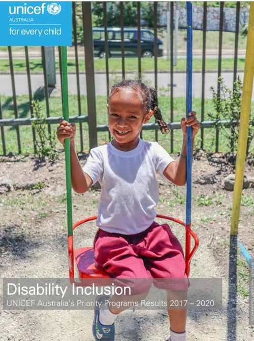 A child with a disability swinging on a accessible swing