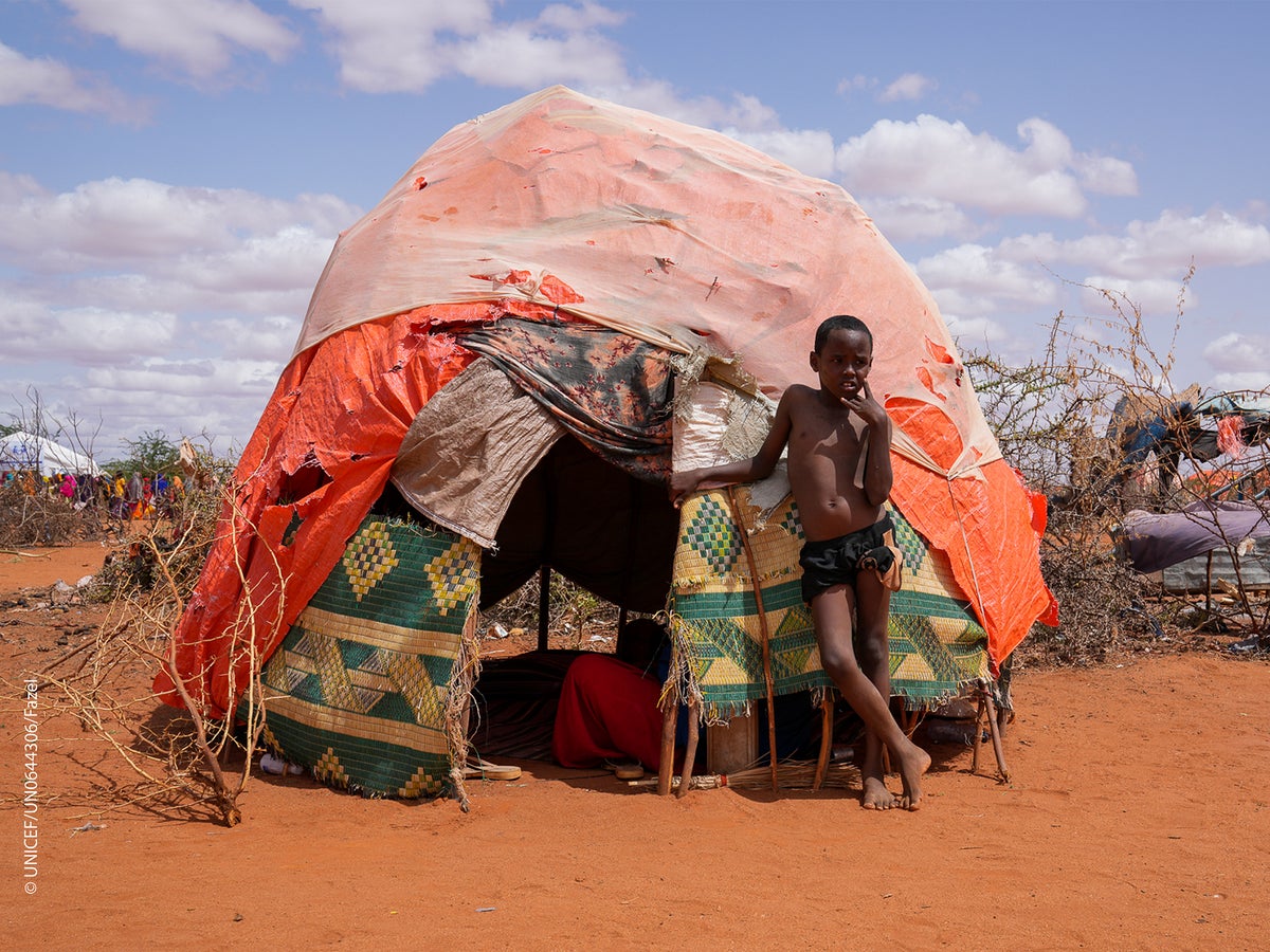 Issak stands in front of his home inside a camp for internally displaced people.