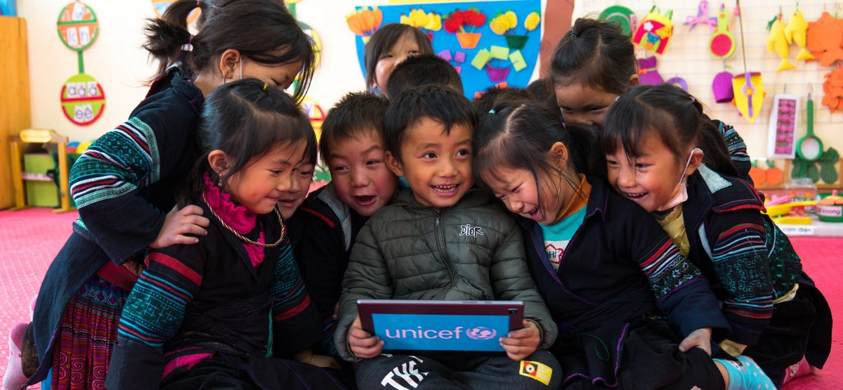 Pre-school student excited when using technology supported by UNICEF in Viet Nam.