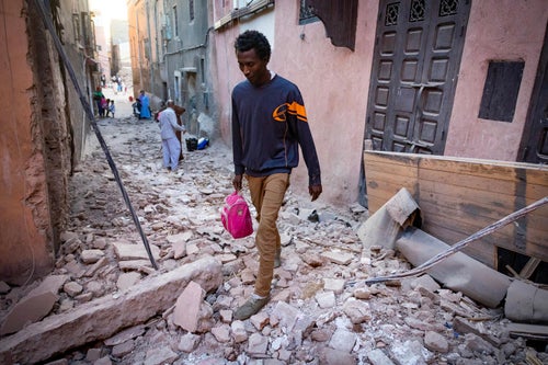 A man walks through the rubble in an alleyway in the earthquake-damaged old city in Marrakesh on September 9, 2023.