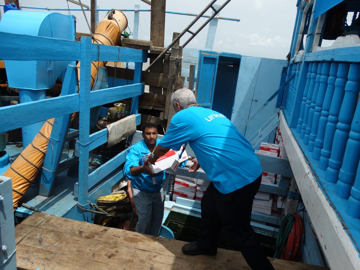 Humanitarian aid supplies are unloaded from a ship