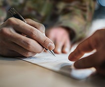 A young solider filling out a form for their PCS entitlements and expenses.