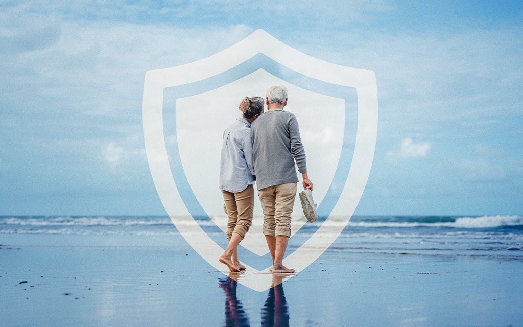 Elderly couple walking on the beach.