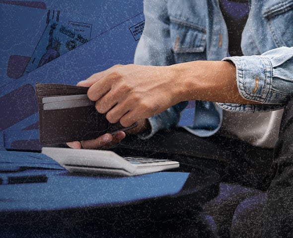 Image of a person opening a wallet while using a calculator.