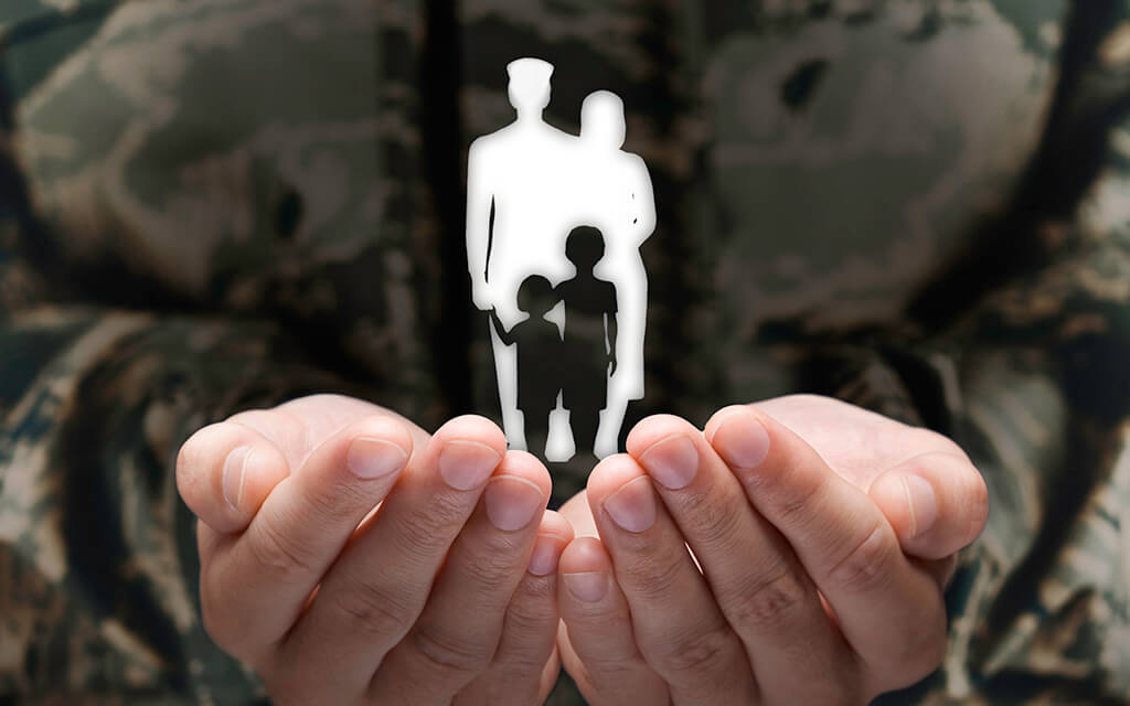 military members hands holding outline of a family