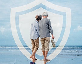 Elderly couple walking on the beach.