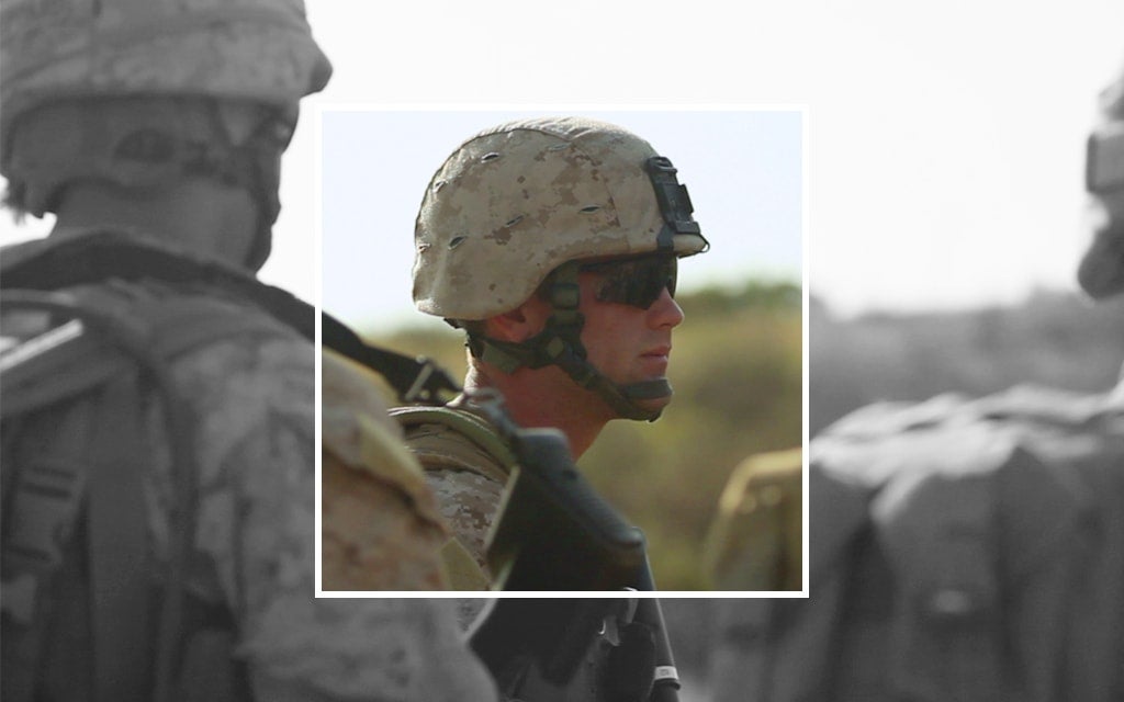 Image of a solider wearing an army helmet and sunglasses.