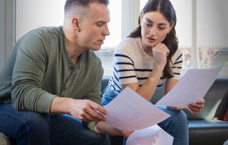 A military couple reviewing their their financial investments.
