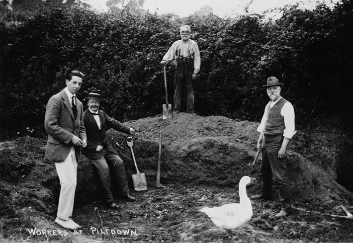 The Piltdown site, with (front row, left to right) Martin Hinton, Charles Dawson, and Arthur Smith Woodward, photograph, ca 1913 (archaeology.org)