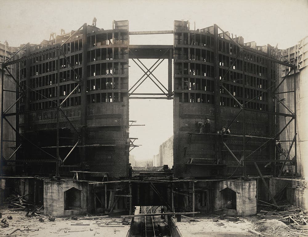 Building a set of lock gates at Gatun.
Each “leaf” of a pair of steel lock gates is massive. The leaves are 65 feet wide and 7 feet deep, but the height varies from 47 to 82 feet, depending on location. The steel gates are hollow and built as a series of water-tight compartments like a ship, so when the locks are filled, the gates are buoyant. View in Digital Collection»