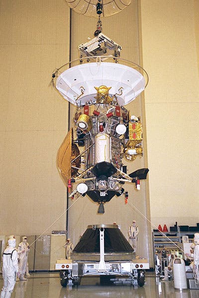 The Cassini-Huygens spacecraft being loaded onto its launch vehicle adapter at Jet Propulsion Lab, July 22, 1997; Huygens is the bronze saucer shape at bottom left of Cassini (Wikimedia commons)