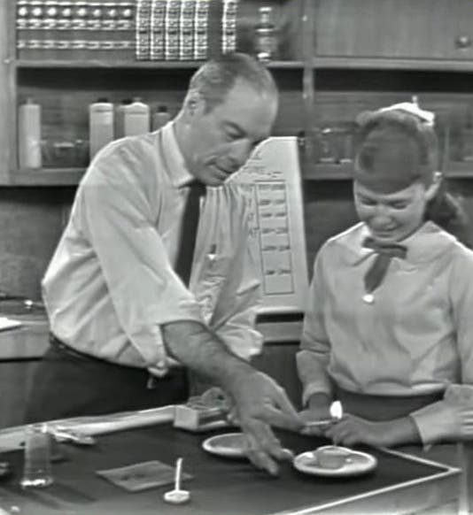 Mr. Wizard (Don Herbert) doing a demonstration with a birthday candle with Rita, “Science in a Candle,” Meet Mr. Wizard, 1964 (youtube.com)