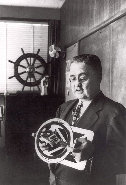 Charles Draper holding model of his inertial guidance system (Air and Technology History Wiki)
