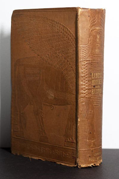 Embossed rear cover and spine of Austen Henry Layard, Discoveries in the Ruins of Nineveh and Babylon, 1853, showing a Lamassu, with cuneiform text embossed at the bottom of both the rear and front covers (Linda Hall Library)