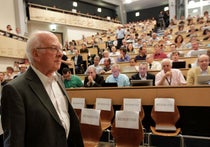 Peter Higgs entering the large seminar room at CERN, 2012, photograph, Washington Post (washingtonpost.com)