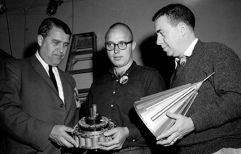 Pioneer 4 space probe, held by Wernher von Braun (left) and James van Allen (right), before its successful launch on Mar. 3, 1959; it was the first spacecraft to escape Earth’s gravitational pull and go into orbit around the Sun (Wikimedia commons)