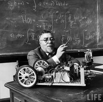 Norbert Wiener in the MIT classroom with his tricycle cart, which he built (with J. Wiesner) with two feedback systems, for demonstration purposes; it was supposed to behave like a “moth” or a “bedbug,” photo from Life Magazine (monoskop.org)