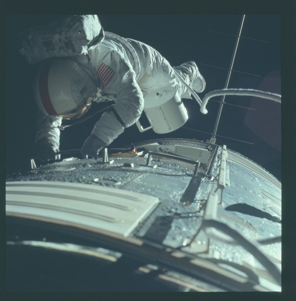 Ron Evans, Apollo 17 Command Module Pilot, retrieves the panoramic camera film canister during an EVA on the return trip to Earth. Evans was outside the spacecraft for 67 minutes. Image source: NASA photograph AS17-152-23391.