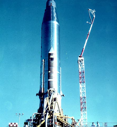 Atlas 10B rocket on the launch pad at Cape Canaveral, with the SCORE tape recorders and radios under the fairings at top, photograph, December 1958 (Wikimedia commons)