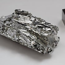 Molybdenum crystalline fragment and cube, an element first isolated by Peter Jacob Hjelm in 1781 (Wikimedia commons)