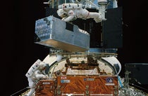 COSTAR, the corrective optics package, being removed from the shuttle by Kathryn Thornton (top) and Thomas Akers, prior to its installation on the Hubble Space Telescope (HST) (science.nasa.gov)