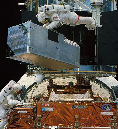 COSTAR, the corrective optics package, being removed from the shuttle by Kathryn Thornton (top) and Thomas Akers, prior to its installation on the Hubble Space Telescope (HST) (science.nasa.gov)