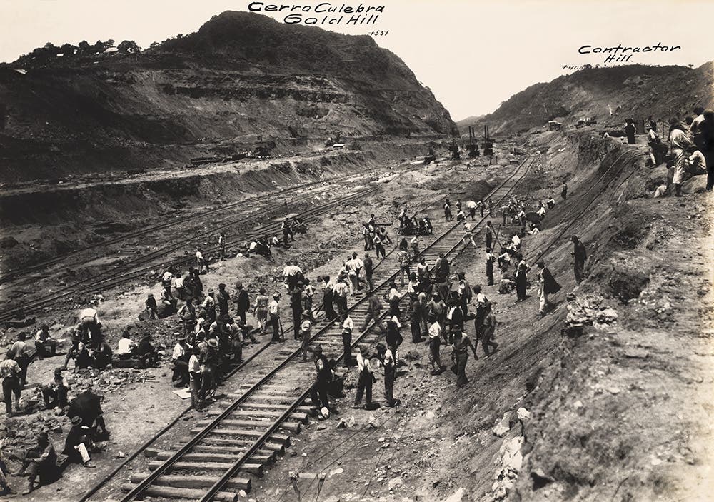 Workers in Culebra Cut enjoy a moment of peace while waiting for the mid-day labor train, June 1911.
In the dangerous and dirty Culebra Cut workers were surrounded by the noise of steam shovels, rushing trains, and hundreds of rock drills, all in temperatures that could reach 120 degrees. Looking into the Cut was, as one observer said, like opening the lid of hell. View in Digital Collection »